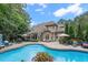 Stunning backyard with a large pool, patio furniture, and lush landscaping perfect for outdoor entertaining at 3530 Thorndike Dr, Wake Forest, NC 27587