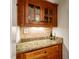Butler pantry features granite countertop and custom wood cabinetry at 3530 Thorndike Dr, Wake Forest, NC 27587