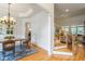 Elegant dining room leading to staircase and living area, featuring hardwood floors at 3530 Thorndike Dr, Wake Forest, NC 27587