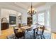 Formal dining room with hardwood floors, bay window, and traditional chandelier at 3530 Thorndike Dr, Wake Forest, NC 27587