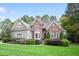 Charming home featuring stone and siding exterior, manicured lawn, and mature trees at 3530 Thorndike Dr, Wake Forest, NC 27587