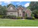 Beautiful home with a well-maintained lawn, mature landscaping, and a mix of stone and siding at 3530 Thorndike Dr, Wake Forest, NC 27587