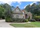 Charming home with a blend of stone and siding, complemented by mature trees and landscaping at 3530 Thorndike Dr, Wake Forest, NC 27587