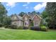 Well-manicured front yard featuring lush greenery, mature trees, and attractive landscaping at 3530 Thorndike Dr, Wake Forest, NC 27587
