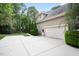 Exterior view showcasing the home's garage, driveway, and surrounding landscaped yard at 3530 Thorndike Dr, Wake Forest, NC 27587