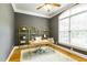 Bright home office with large window, modern desk, stylish shelves, and neutral walls at 3530 Thorndike Dr, Wake Forest, NC 27587