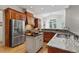 Bright kitchen features stainless steel appliances, granite counters and an island at 3530 Thorndike Dr, Wake Forest, NC 27587