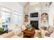 Bright living room featuring fireplace, built-in shelves, and comfortable armchairs at 3530 Thorndike Dr, Wake Forest, NC 27587