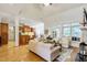 Open-concept living room with hardwood floors, abundant natural light, and partial kitchen view at 3530 Thorndike Dr, Wake Forest, NC 27587