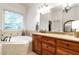 Main bathroom featuring granite countertops, jacuzzi tub, and ample storage at 3530 Thorndike Dr, Wake Forest, NC 27587