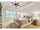 Bright main bedroom featuring tray ceiling, natural light, and neutral decor at 3530 Thorndike Dr, Wake Forest, NC 27587