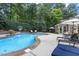 Backyard pool area featuring a well-maintained pool, sun loungers, and lush greenery at 3530 Thorndike Dr, Wake Forest, NC 27587