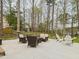 Cozy back patio with outdoor seating, perfect for relaxing among tall trees and a fenced yard at 3705 Andoversford Ct, Wake Forest, NC 27587