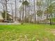 Secluded backyard featuring a patio with outdoor seating, lush green grass, and mature trees at 3705 Andoversford Ct, Wake Forest, NC 27587