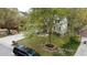 View of backyard including mature tree, stone-lined flower bed, and partial view of white home siding at 3705 Andoversford Ct, Wake Forest, NC 27587