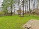 Spacious backyard featuring a lush green lawn, mature trees, and a tranquil outdoor setting at 3705 Andoversford Ct, Wake Forest, NC 27587