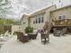 Exterior shot of a home and its backyard featuring a concrete patio and an outdoor seating area at 3705 Andoversford Ct, Wake Forest, NC 27587