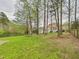 Expansive backyard with lush green lawn, a wooden fence, and mature trees creating a peaceful setting at 3705 Andoversford Ct, Wake Forest, NC 27587