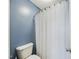 Neutral bathroom features a toilet and a shower with a white shower curtain at 3705 Andoversford Ct, Wake Forest, NC 27587