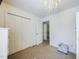 Bright bedroom featuring neutral carpet, chandelier lighting, and closet storage at 3705 Andoversford Ct, Wake Forest, NC 27587