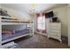 bedroom featuring a bunk bed, chandelier, and a wall-mounted television at 3705 Andoversford Ct, Wake Forest, NC 27587