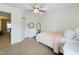 Neutral carpeted bedroom offers a twin bed, a dresser, a mirror, and a ceiling fan at 3705 Andoversford Ct, Wake Forest, NC 27587
