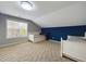 Bedroom with two twin beds, carpeted floors, and blue accent wall at 3705 Andoversford Ct, Wake Forest, NC 27587