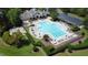 Expansive community pool area with ample seating, umbrellas, well-kept landscaping, and clubhouse at 3705 Andoversford Ct, Wake Forest, NC 27587