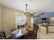 Well-lit dining area adjacent to the kitchen, featuring a wooden table, and offering views of the connected living space at 3705 Andoversford Ct, Wake Forest, NC 27587