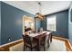Dining room with stylish light fixture, table setting, and archway view into office at 3705 Andoversford Ct, Wake Forest, NC 27587