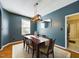 Dining room with wooden table, six chairs, light fixture, and light blue walls at 3705 Andoversford Ct, Wake Forest, NC 27587