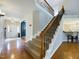 Spacious entryway with hardwood floors, staircase, and an open view into other living spaces at 3705 Andoversford Ct, Wake Forest, NC 27587