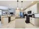 Spacious eat-in kitchen boasts white cabinetry, black appliances, and a large central island, perfect for Gathering gatherings at 3705 Andoversford Ct, Wake Forest, NC 27587