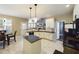 Bright, open kitchen with white cabinets, countertops, and island, providing seamless access to the dining area at 3705 Andoversford Ct, Wake Forest, NC 27587
