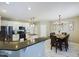 Well-lit kitchen featuring white cabinets, granite countertops, stainless steel appliances, and an adjacent dining area at 3705 Andoversford Ct, Wake Forest, NC 27587