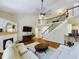 Bright living room boasts a fireplace, hardwood floors, staircase to the second floor and comfortable white sectional sofa at 3705 Andoversford Ct, Wake Forest, NC 27587