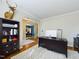 Home office with dark desk, bookcase and view through archway to dining room at 3705 Andoversford Ct, Wake Forest, NC 27587
