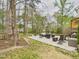 Spacious backyard features a concrete patio area with an outdoor seating arrangement at 3705 Andoversford Ct, Wake Forest, NC 27587