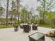 Wide shot of a concrete patio featuring an outdoor seating arrangement and a string of lights at 3705 Andoversford Ct, Wake Forest, NC 27587