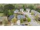 Gorgeous aerial view showcasing the home nestled within a tree-lined neighborhood with manicured lawns at 3725 Song Sparrow Dr, Wake Forest, NC 27587