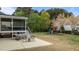 Inviting backyard with screened porch, patio seating, and play structure, ideal for Gathering enjoyment at 3725 Song Sparrow Dr, Wake Forest, NC 27587