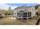 Well-maintained backyard with a screened porch, patio, and lush greenery, perfect for outdoor gatherings at 3725 Song Sparrow Dr, Wake Forest, NC 27587