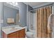 The bathroom has a vanity sink, a toilet, and a shower-tub combo with a patterned curtain at 3725 Song Sparrow Dr, Wake Forest, NC 27587