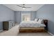 This bedroom features a wooden bed frame, dresser and light blue walls at 3725 Song Sparrow Dr, Wake Forest, NC 27587