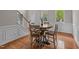 Inviting dining area with hardwood floors, a round wooden table, and a view of the staircase and front entrance at 3725 Song Sparrow Dr, Wake Forest, NC 27587