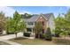 Charming two-story home with a combination of brick and siding, complemented by lush landscaping and a well-manicured lawn at 3725 Song Sparrow Dr, Wake Forest, NC 27587