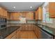 The large kitchen has ample counter and cabinet space, stainless steel appliances and hardwood floors at 3725 Song Sparrow Dr, Wake Forest, NC 27587