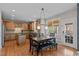 Eat-in kitchen with a table and chairs that features granite countertops, an island and wood cabinets at 3725 Song Sparrow Dr, Wake Forest, NC 27587