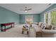 Spacious living room featuring neutral tones, ceiling fan, and natural light, perfect for relaxation at 3725 Song Sparrow Dr, Wake Forest, NC 27587