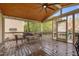 Enjoy outdoor living on this screened-in porch with wood ceiling, ceiling fan and comfortable seating at 3725 Song Sparrow Dr, Wake Forest, NC 27587